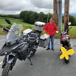 Bruce with his wife and their two motorcycles. 