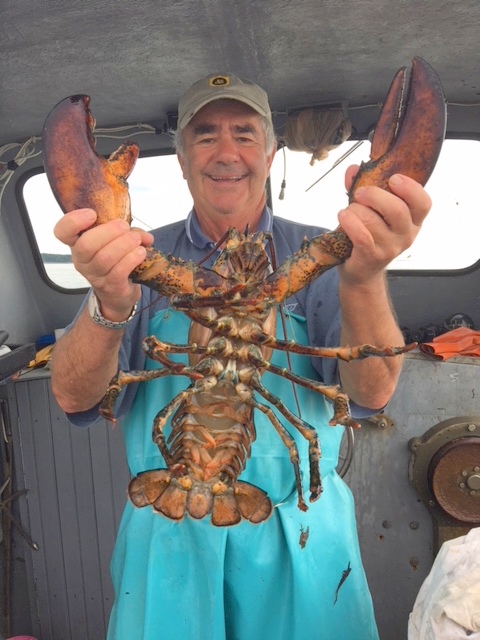 Dean Crombie showing off a lobster he caught