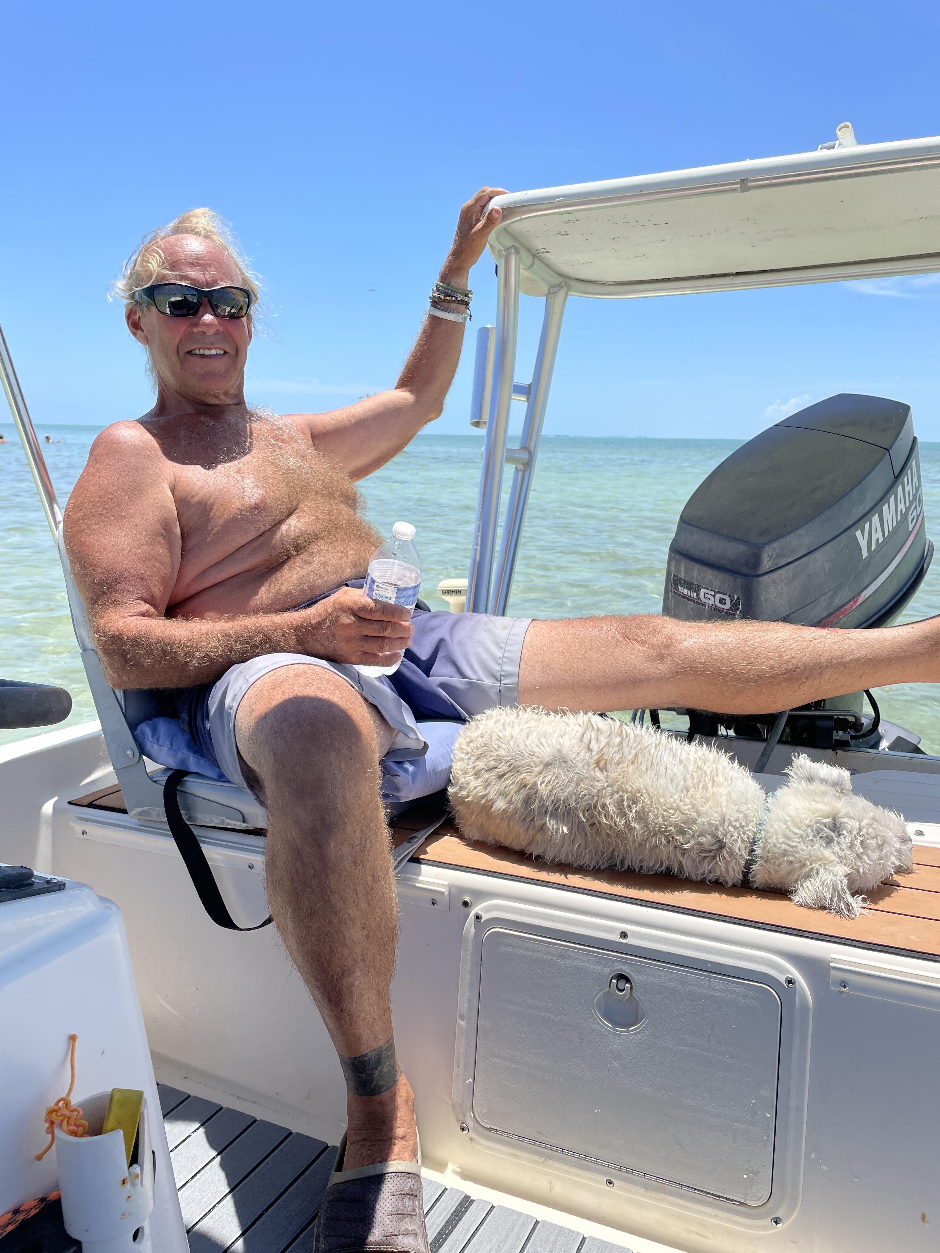Man sitting on a boat in the ocean. 