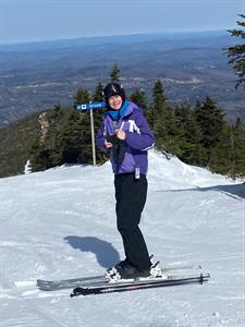 Donna Moody in skis at the top of a mountain