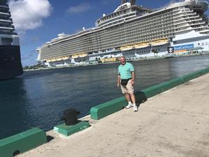 Michael Royce standing in front of a cruise ship
