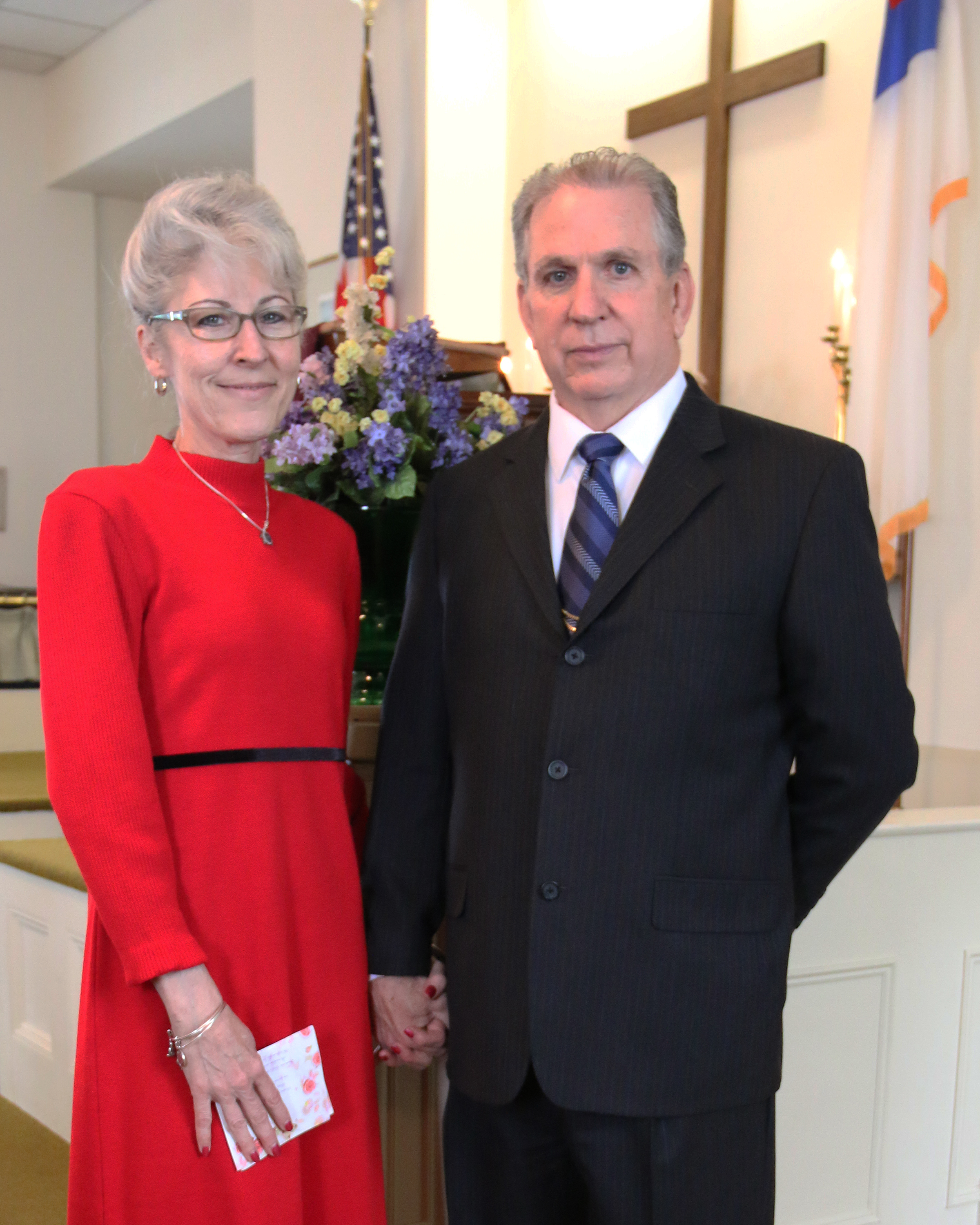 Steve and Pamela standing together holding hands